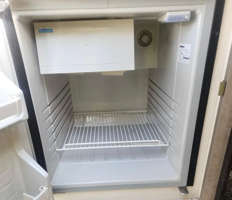 Slide: The Image of Empty refrigerator inside a 2008 Formula 330 Sun Sport boat. - 14