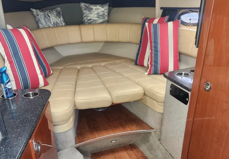 Slide: The Image of 2008 Formula 330 Sun Sport cabin with beige seating and striped pillows. - 16