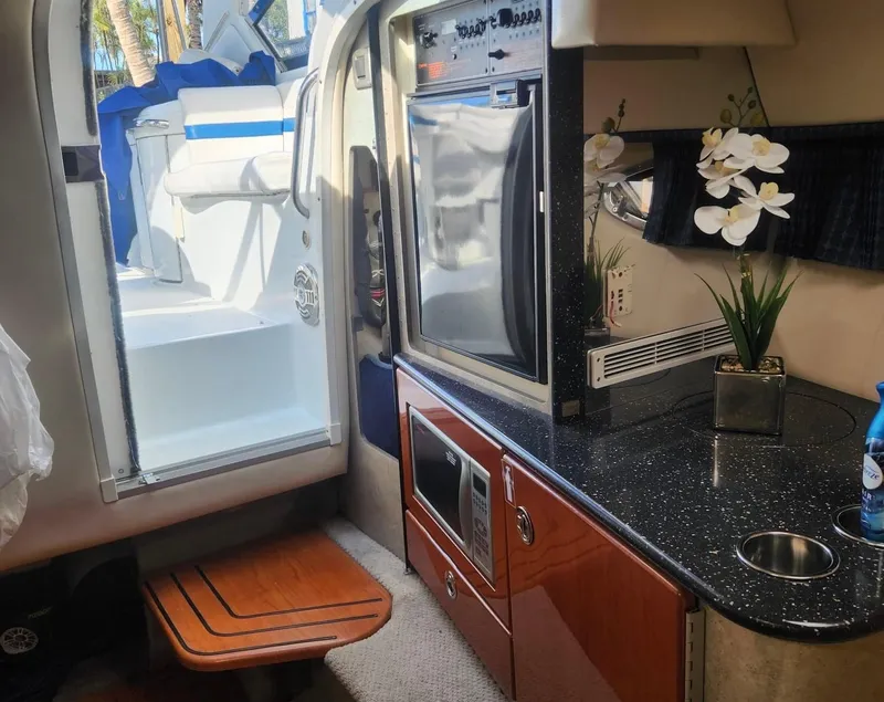 Slide: The Image of Interior of 2008 Formula 330 Sun Sport boat with kitchenette and seating area. - 17