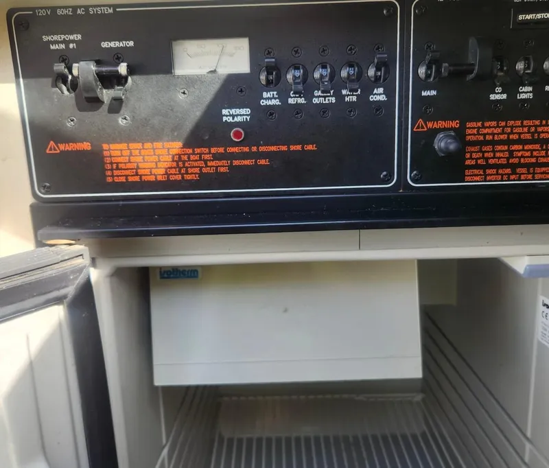 Slide: The Image of Control panel and open fridge in 2008 Formula 330 Sun Sport boat. - 18