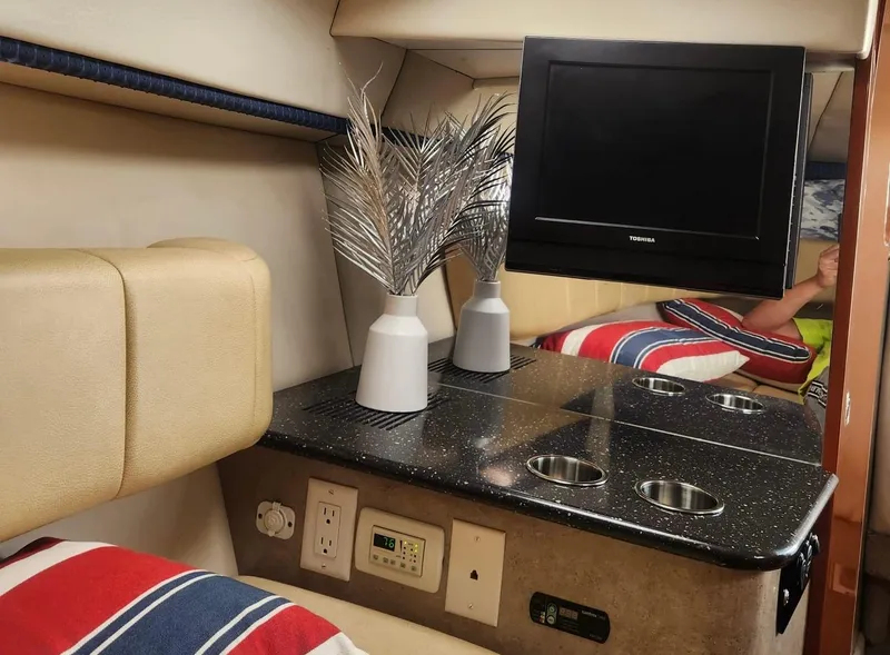 Slide: The Image of Interior of 2008 Formula 330 Sun Sport with TV, vases, and striped pillows. - 19