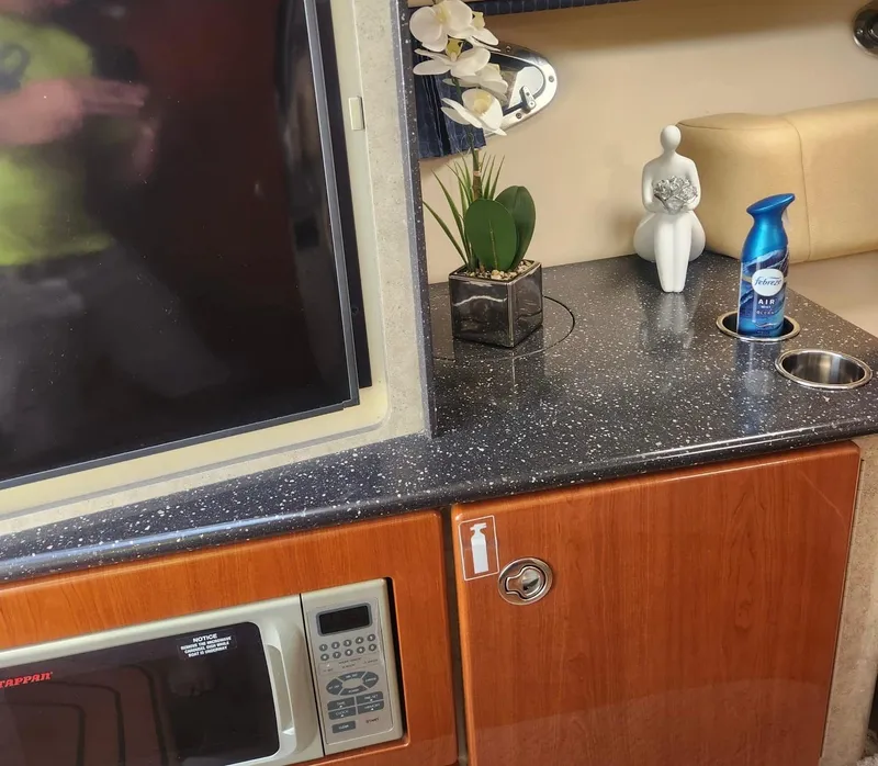 Slide: The Image of Interior of 2008 Formula 330 Sun Sport with microwave, countertop decor, and cleaning spray. - 20