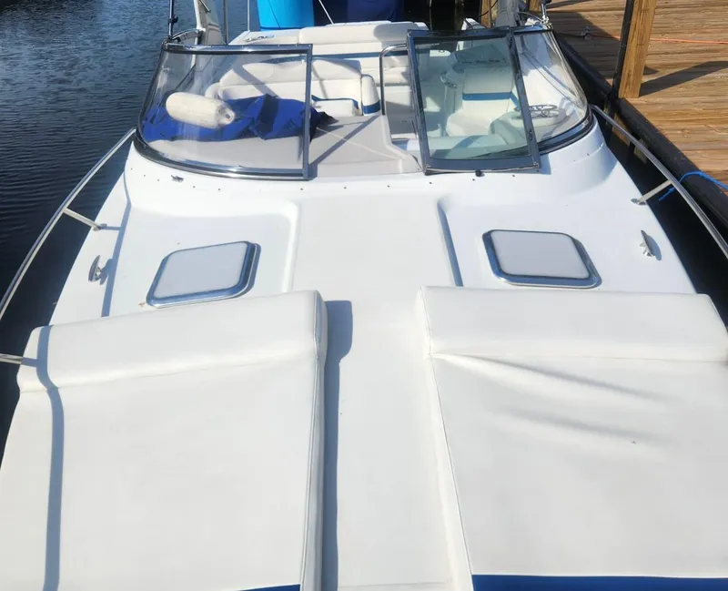 Slide: The Image of 2008 Formula 330 Sun Sport boat with white deck and seating, docked by the water. - 23