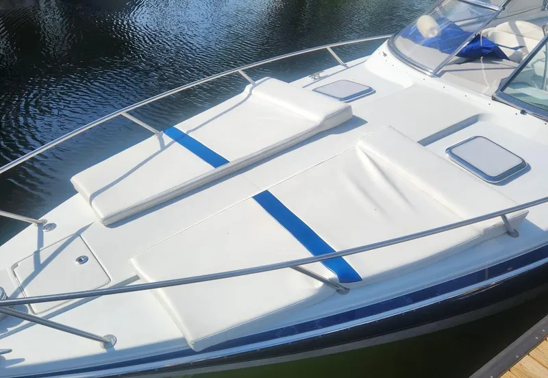 Slide: The Image of 2008 Formula 330 Sun Sport boat with white deck and blue accents on water. - 24
