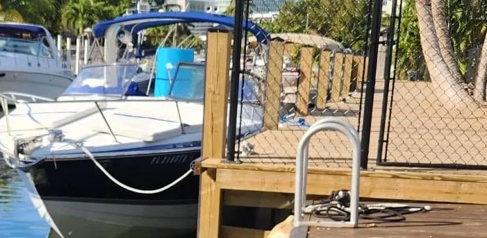 Slide: The Image of 2008 Formula 330 Sun Sport docked at a marina with palm trees in the background. - 26