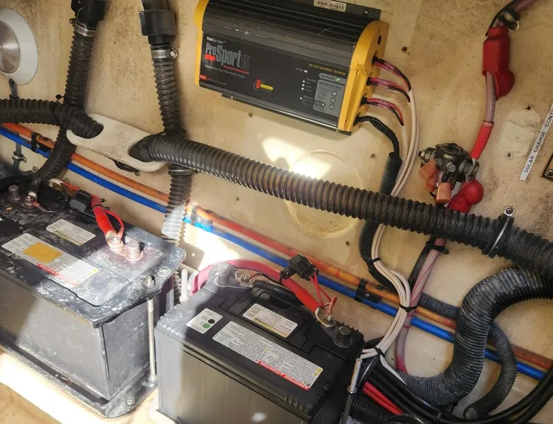 Slide: The Image of 2008 Formula 330 Sun Sport boat battery compartment with wiring and charger. - 9