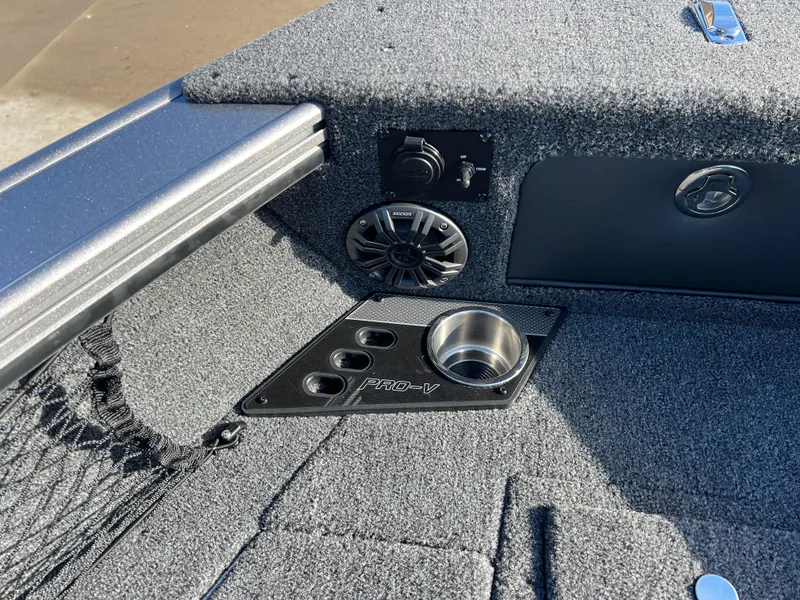 Slide: The Image of 2025 Lund 1875 Pro-V boat interior with speaker and cup holder. - 11