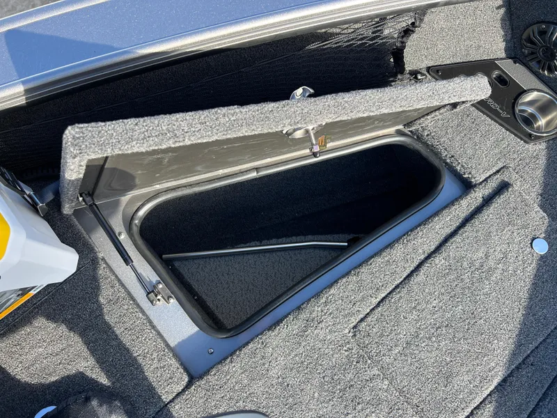 Slide: The Image of 2025 Lund 1875 Pro-V boat storage compartment with open lid, showcasing interior space. - 12
