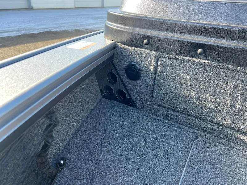 Slide: The Image of 2025 Lund 1875 Pro-V boat interior with carpeted storage compartment. - 15