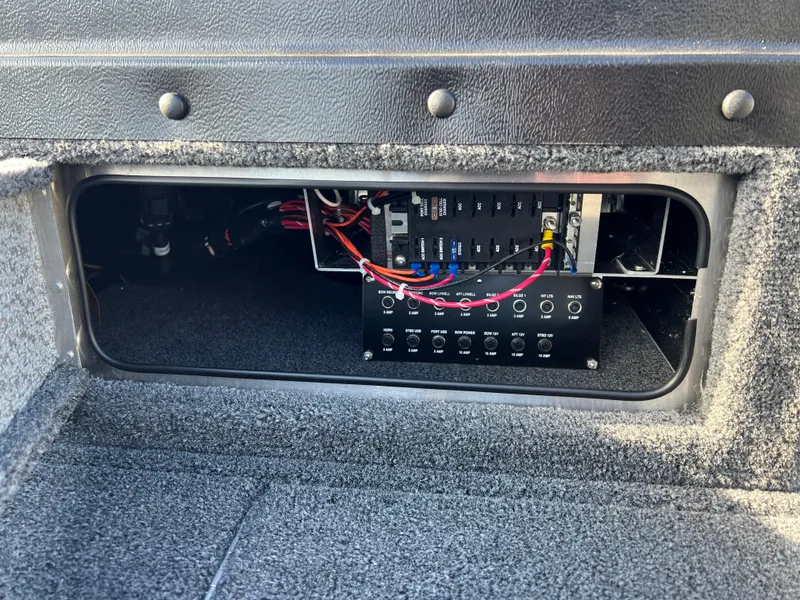 Slide: The Image of Electrical panel inside 2025 Lund 1875 Pro-V boat compartment. - 16