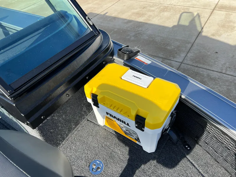 Slide: The Image of 2025 Lund 1875 Pro-V boat interior with a yellow and white tackle box. - 17
