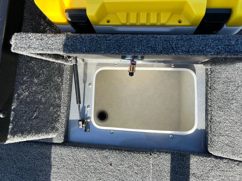 Slide: The Image of Open storage compartment in 2025 Lund 1875 Pro-V boat with carpeted interior. - 18