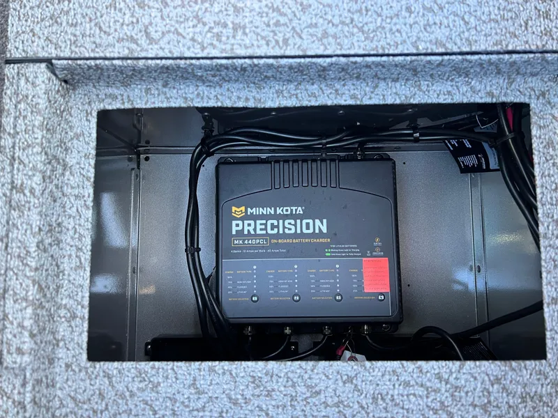 Slide: The Image of Minn Kota Precision charger in 2025 Lund 1875 Pro-V boat compartment. - 20