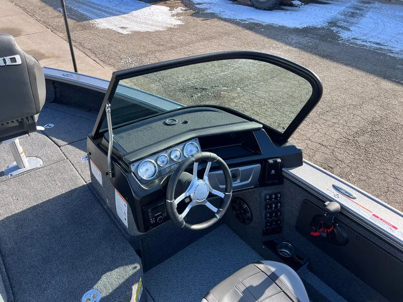 Slide: The Image of 2025 Lund 1875 Pro-V boat interior with steering wheel and dashboard controls. - 24