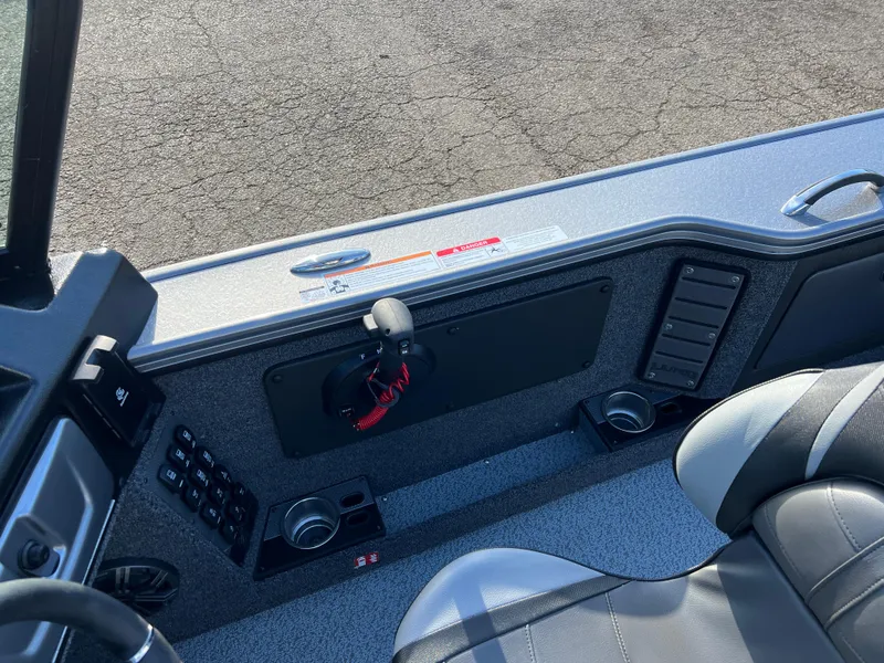Slide: The Image of Interior of 2025 Lund 1875 Pro-V boat, featuring control panel and seating. - 27