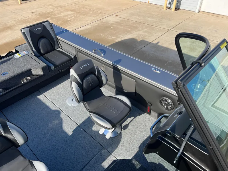 Slide: The Image of 2025 Lund 1875 Pro-V boat interior with seating and console. - 28