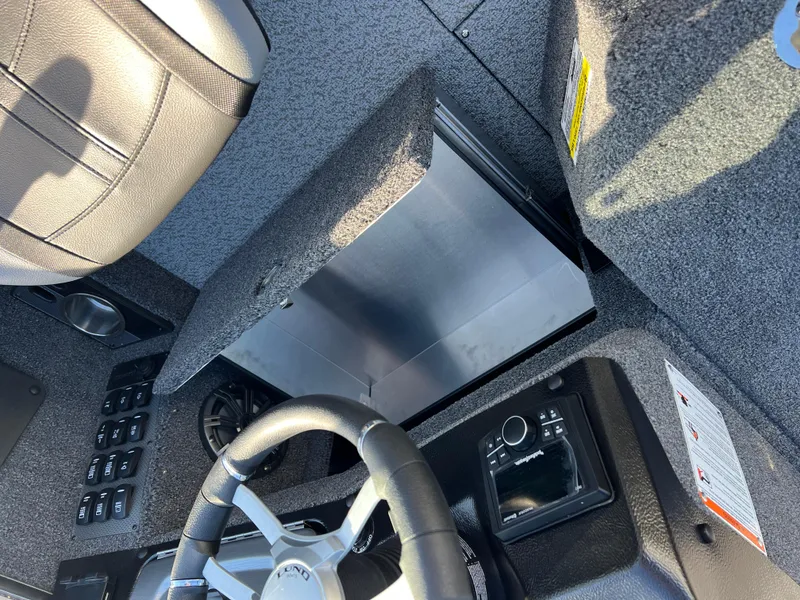 Slide: The Image of 2025 Lund 1875 Pro-V boat interior with steering wheel and control panel. - 29