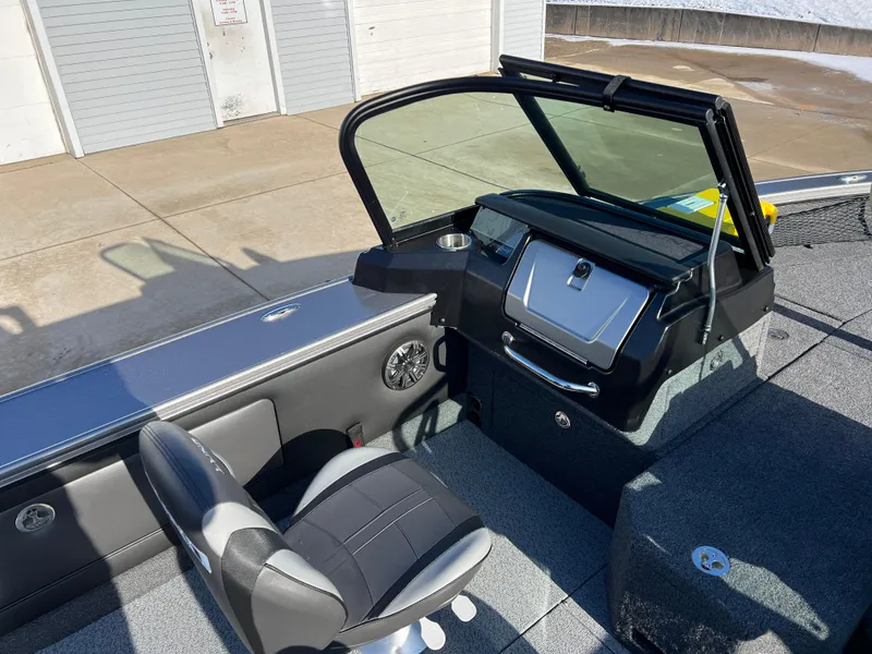 Slide: The Image of 2025 Lund 1875 Pro-V boat interior with steering console and seating. - 30