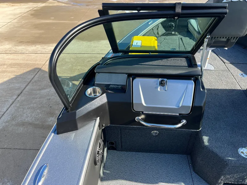 Slide: The Image of 2025 Lund 1875 Pro-V boat interior with windshield and storage compartment. - 31