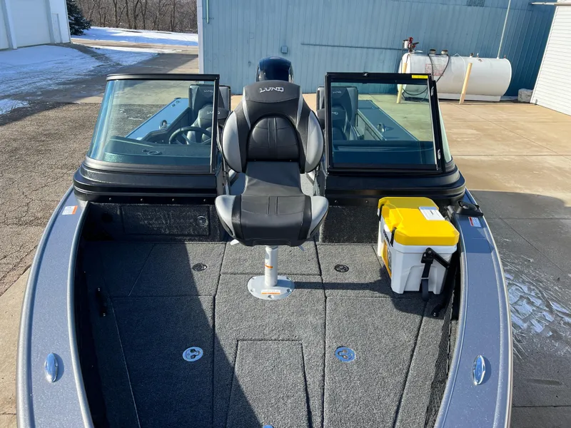 Slide: The Image of 2025 Lund 1875 Pro-V boat with seating and storage on a sunny day. - 8