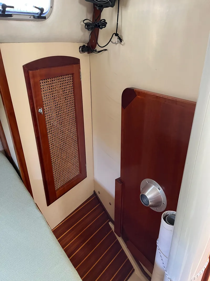 Slide: The Image of Interior of 2006 Shannon Shoalsailer with wooden cabinetry and nautical design elements. - 15
