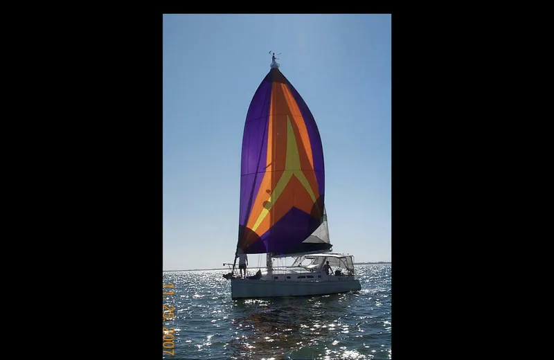 Slide: The Image of Sailboat on water with colorful sail, Shannon Shoalsailer 2006 model. - 2