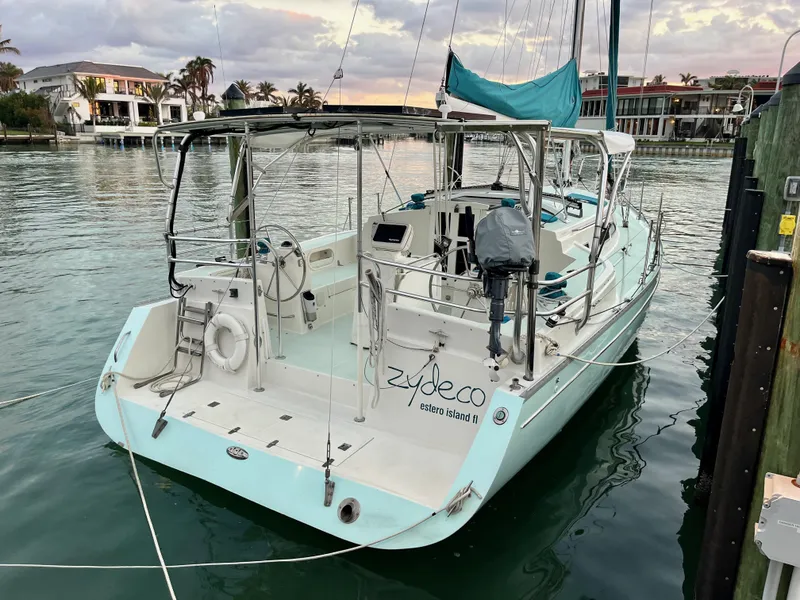 Slide: The Image of 2006 Shannon Shoalsailer yacht docked in a serene marina setting. - 5