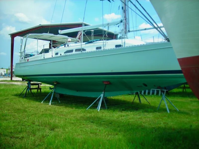 Slide: The Image of 2006 Shannon Shoalsailer sailboat on stands in grassy yard. - 7
