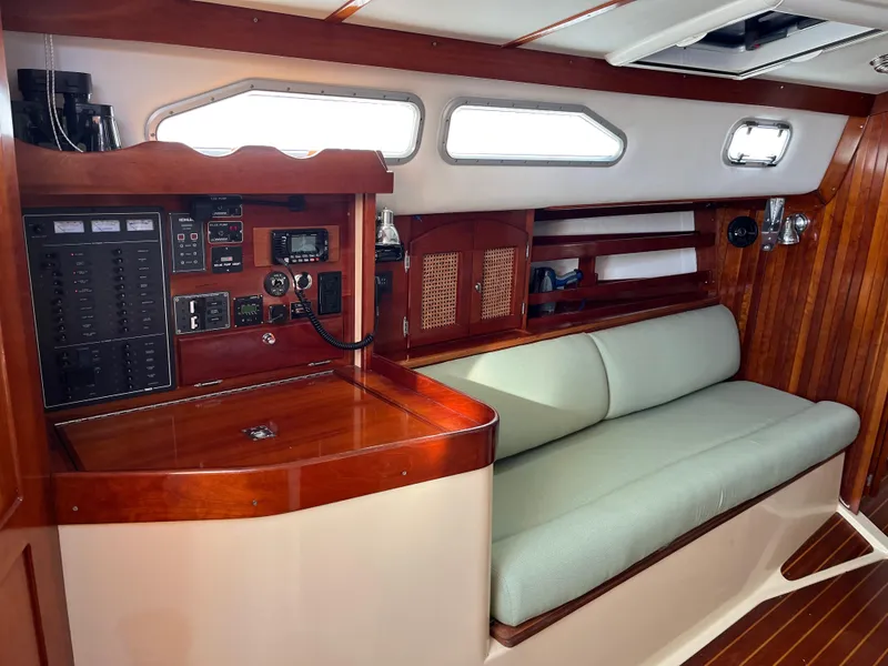 Slide: The Image of 2006 Shannon Shoalsailer interior with wooden paneling, navigation equipment, and cushioned seating. - 8
