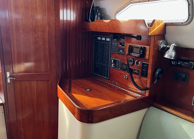 Slide: The Image of Navigation station in 2006 Shannon Shoalsailer, featuring wood paneling and electronic equipment. - 9