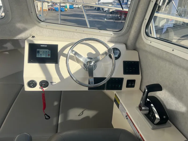 Slide: The Image of 2023 Defiance Admiral 220 EX boat helm with steering wheel and control panel. - 14