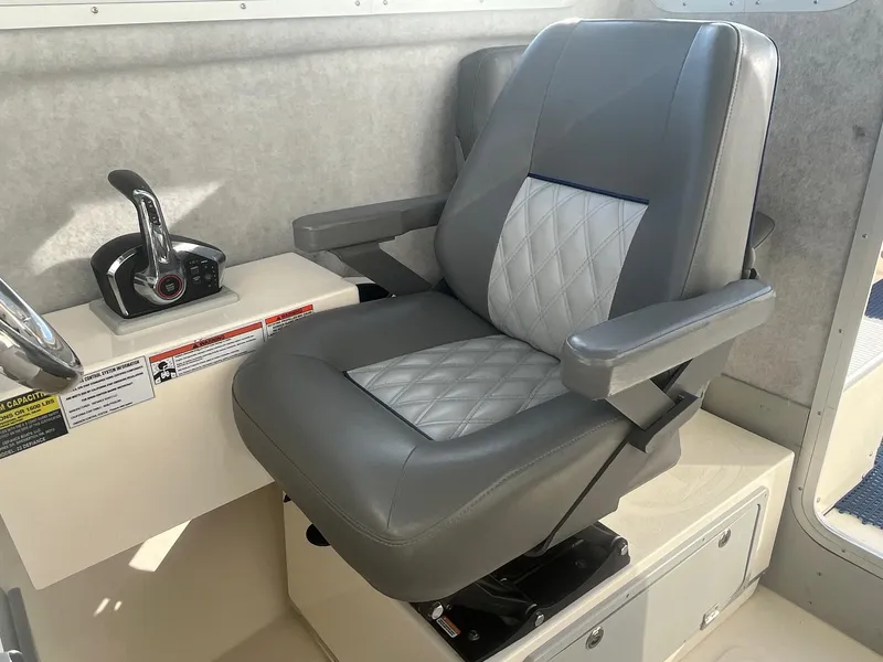 Slide: The Image of 2023 Defiance Admiral 220 EX captain's chair with control panel, gray and white upholstery. - 15