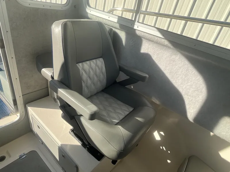 Slide: The Image of 2023 Defiance Admiral 220 EX interior with a comfortable, modern captain's chair. - 16