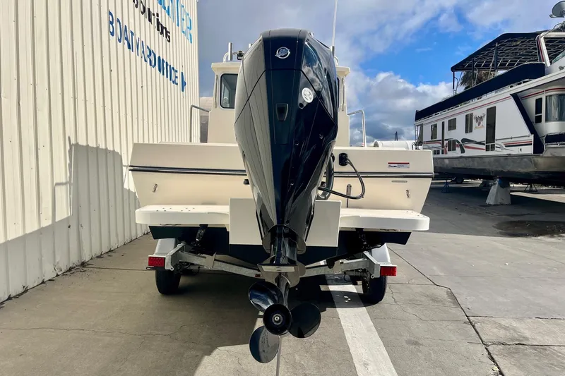 Slide: The Image of 2023 Defiance Admiral 220 EX boat on trailer, rear view with outboard motor. - 6