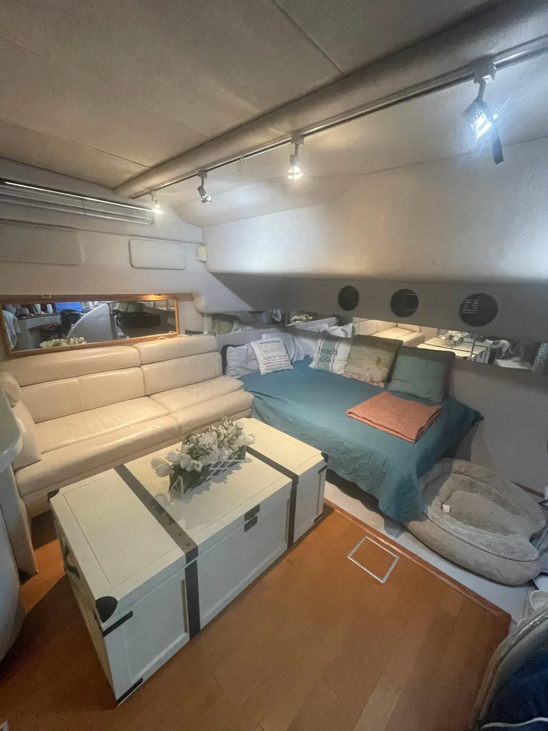 Slide: The Image of Interior of 1991 Sea Ray Sun Dancer 480 Express, featuring cozy seating and modern decor. - 10