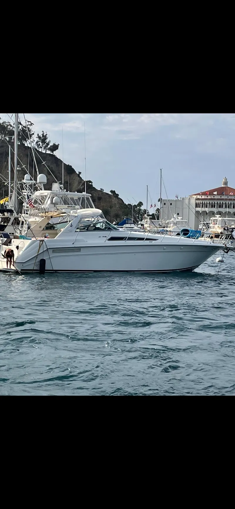 Slide: The Image of 1991 Sea Ray Sun Dancer 480 Express yacht docked in a marina. - 22