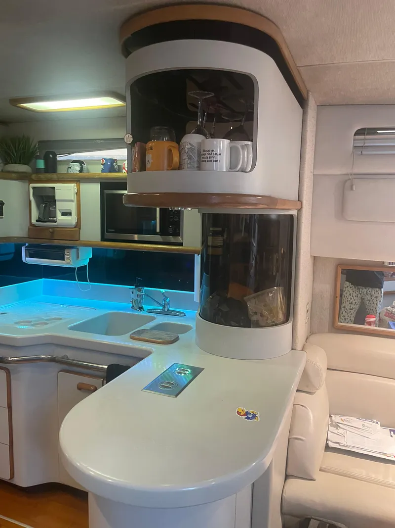 Slide: The Image of Interior of 1991 Sea Ray Sun Dancer 480 Express yacht with modern kitchen amenities. - 7