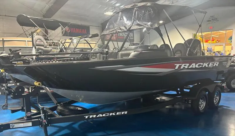 Slide: The Image of 2025 Tracker Targa™ V-18 WT boat displayed indoors on a trailer. - 3