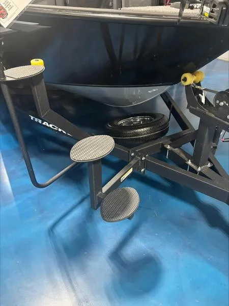 Slide: The Image of 2025 Tracker Targa™ V-18 WT boat trailer with step ladder on blue floor. - 4