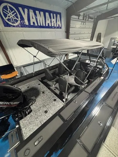 Slide: The Image of 2025 Tracker Targa™ V-18 WT boat with canopy in showroom, Yamaha banner visible. - 6