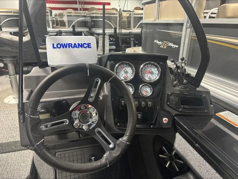 Slide: The Image of 2025 Tracker Targa™ V-18 WT boat dashboard with Lowrance display and gauges. - 8