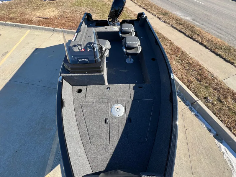 Slide: The Image of 2025 Lund 1650 Rebel XL SS fishing boat, top view, parked on pavement. - 11