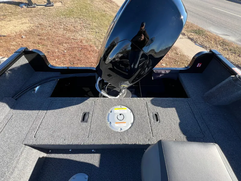 Slide: The Image of 2025 Lund 1650 Rebel XL SS boat interior with motor and seating. - 13