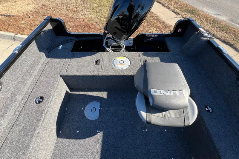 Slide: The Image of 2025 Lund 1650 Rebel XL SS boat interior with seating and motor. - 14