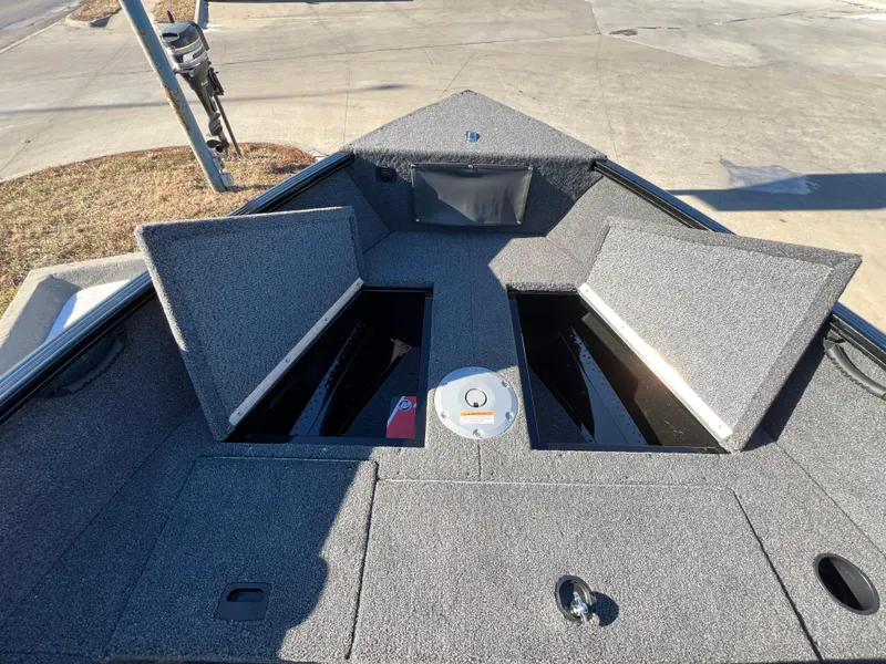 Slide: The Image of 2025 Lund 1650 Rebel XL SS boat interior with open storage compartments. - 7