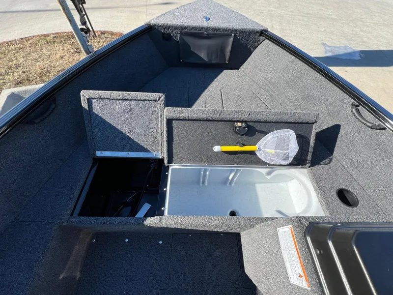 Slide: The Image of 2025 Lund 1650 Rebel XL SS boat interior with storage compartments and fishing net. - 8