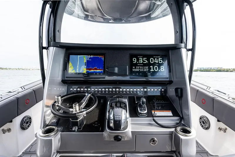 Slide: The Image of 2021 Fountain 39 NX boat dashboard with navigation screens and controls on open water. - 14