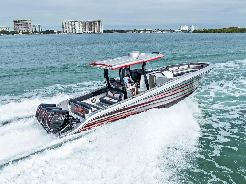 The Image of 2021 Fountain 39 NX boat cruising on open water with cityscape in background. - 0