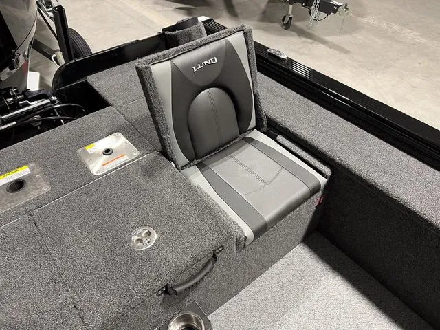 Slide: The Image of 2025 Lund 2075 Pro-V Bass XS boat seat with gray upholstery and storage compartments. - 10
