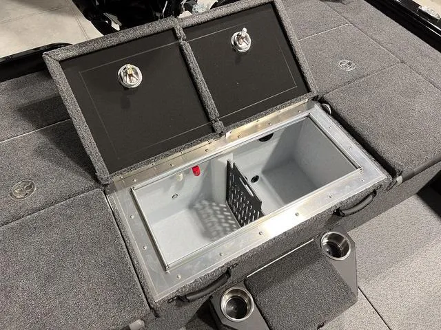 Slide: The Image of 2025 Lund 2075 Pro-V Bass XS boat with open storage compartment and cup holders. - 11